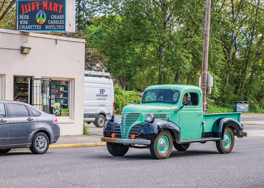 An early 1940s era Plymouth PT 105 truck drives down Main Street in Battle Ground on Monday, May 8.