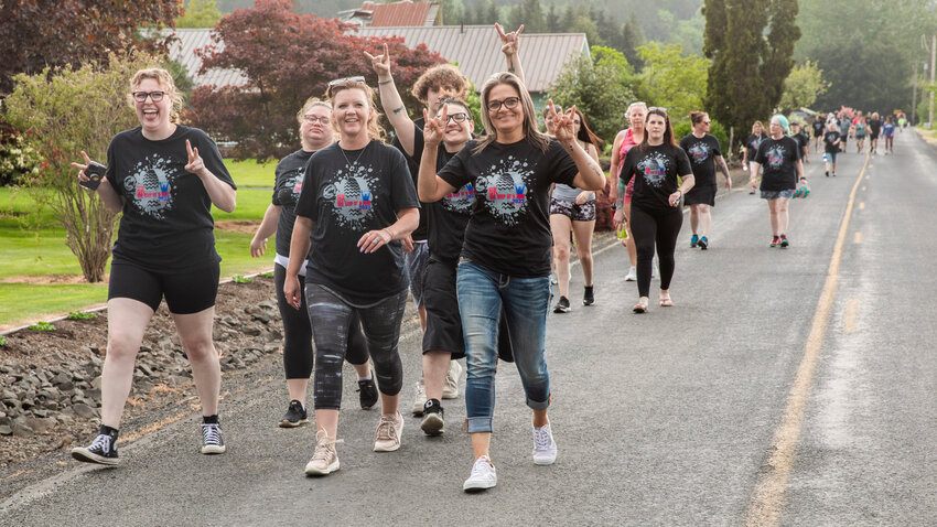 Participants smile and pose for a photo during the &ldquo;One Step At A Time 5K&rdquo; in Chehalis on Monday, May 15.