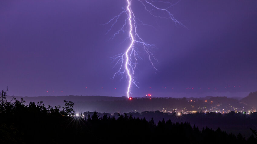Lightning strikes in the hills east of Chehalis Monday night as a thunderstorm moves through the area.