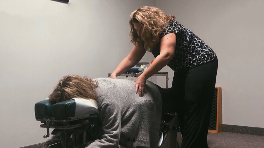 Dr. Karen Stevens-Barnes works on a client at her practice, Nu-Life Wellness Center, in Battle Ground.