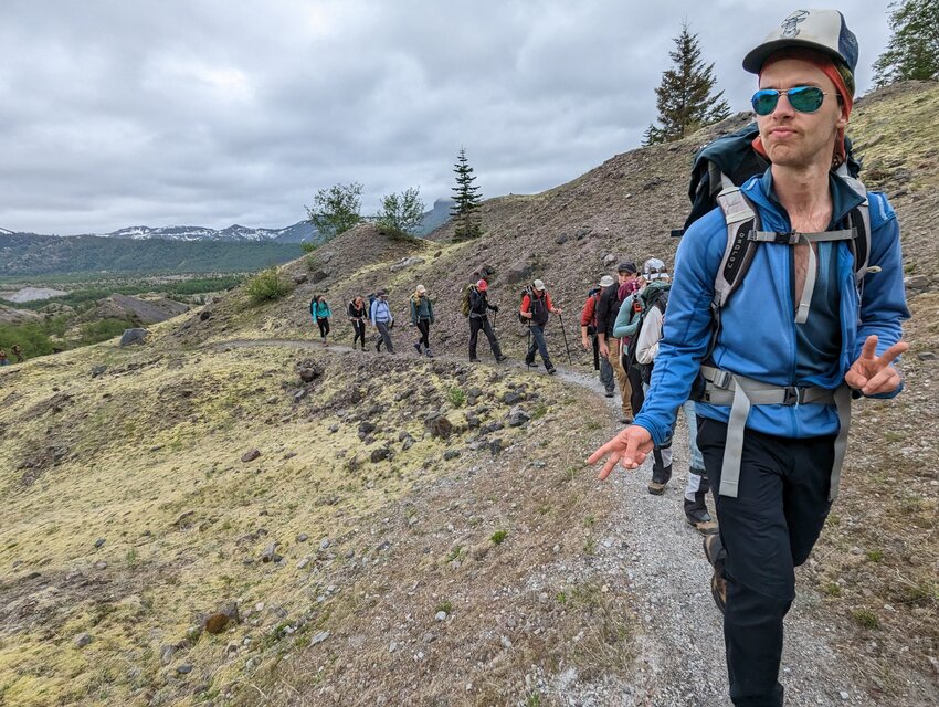 Volunteers hike to the Johnston Ridge Observatory on May 24 to retrieve equipment after a landslide earlier this month cut off access to the site.