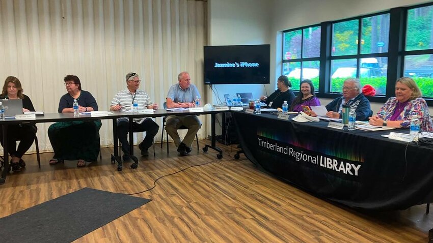 The Timberland Regional Library Board of Trustees gathered Wednesday in Shelton. Brian Zylstra, Lewis County&rsquo;s former representative on the board, is pictured to the left of the television screen. He resigned his position this week.