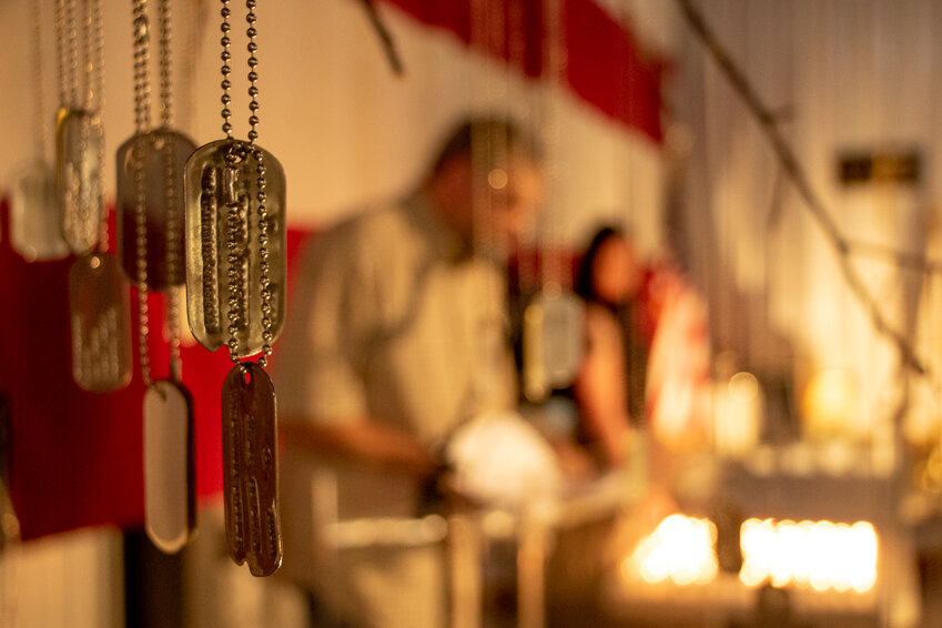 Dog tags with the names of fallen service members can be seen hanging from the Tree of Life display at the Veterans Memorial Museum on Monday.
