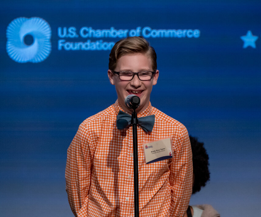 Brady &quot;Bruz&quot; Taylor, a sixth-grader at Chehalis Middle School, smiles as he answers a question about his speech on addressing homelesses as he competes in the final round of the state Civics Bee championship Nine middle-school students -- including three from Chehalis -- competed in the Washington Civics Bee championship, emceed by Secretary of State Steve Hobbs, at the Museum of Flight in Seattle on Thursday, June 1, 2023. (Photo: Brian Mittge/AWB)