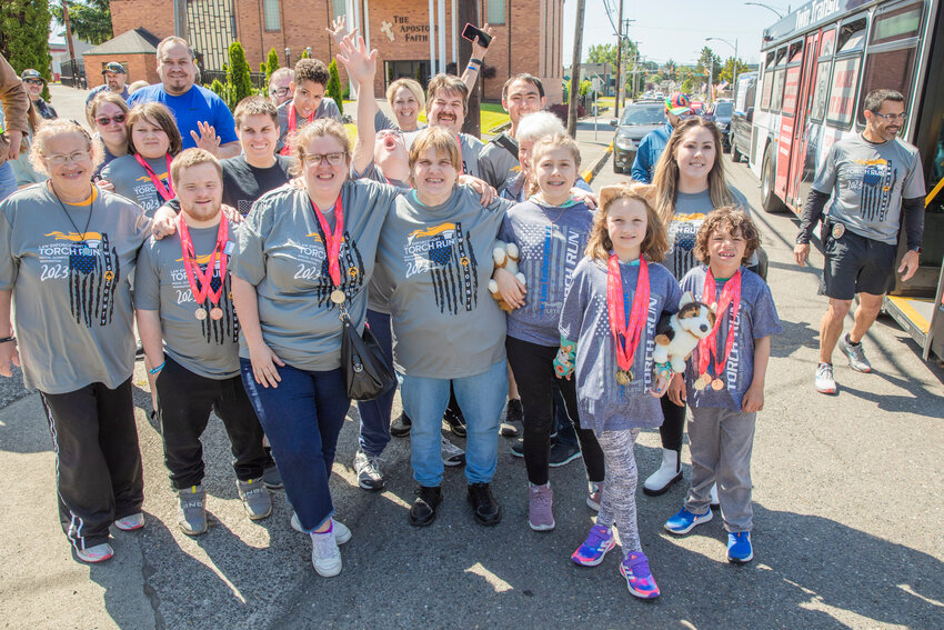 Participants in the Lewis County Special Olympics Law Enforcement Torch Run pose for a photo in Chehalis on Friday, June 2.