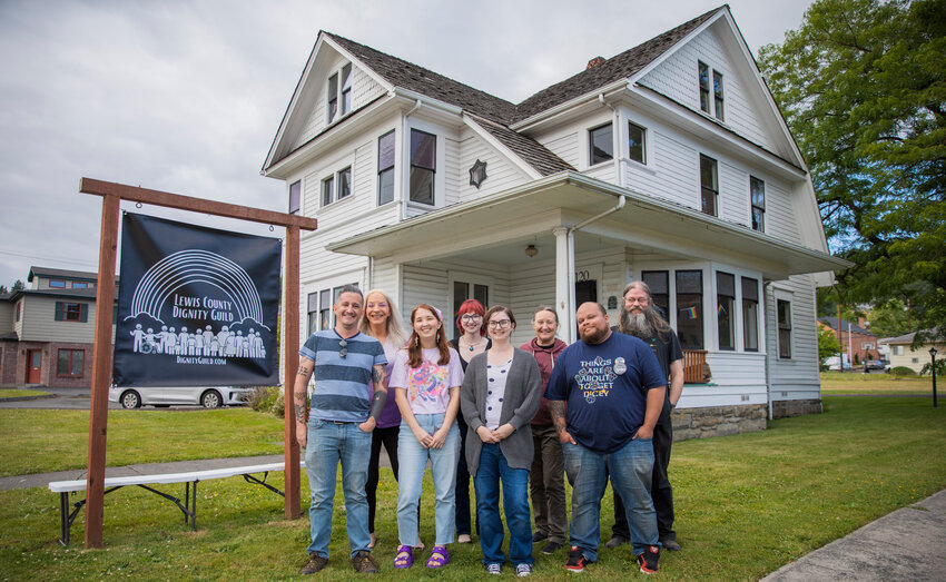 Lewis County Dignity Guild board members smile for a photo in front of their new location in Chehalis on Wednesday. Clockwise from left they are Kyle Wheeler, president; Sandy Beach, board member; Justine Pense, secretary; Gillian Davis, board member; Bill Vollmer, board member; Theodore Terry, board member; Jacky Sjoblom, treasurer; and Luj&aacute;n Rodr&iacute;guez, vice president. Not pictured is board member Sara Smiley.