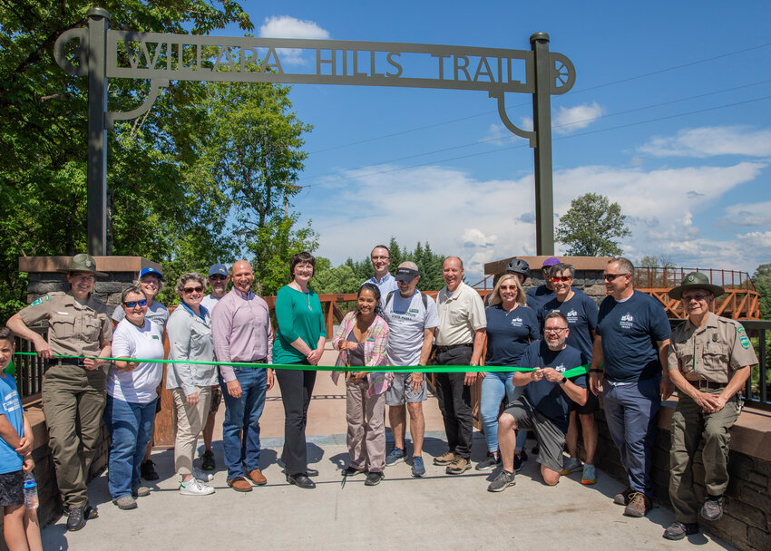 Washington State Parks Vice Chair Sophia Danenberg smiles as she prepares to cut the ribbon during a ceremony marking the official opening of the Willapa Hills State Park Trail in Littell on Friday. According to Washington State Parks, the  new bridge over state Route 6 is meant to provide trail users a safe crossing as they bike, walk or ride on horseback on the trail.  &ldquo;The new bridge was built through a collaborative process between Parks and the local community to address safety concerns at the intersection of the trail and SR 6,&rdquo;  Washington State Parks noted in a news release. &ldquo;The old intersection required users to navigate a crossing that was at the same grade as the highway in an area with limited sight distance. Now, trail-goers have an overpass, so they don&rsquo;t have to pause their journey to look for traffic.&rdquo;