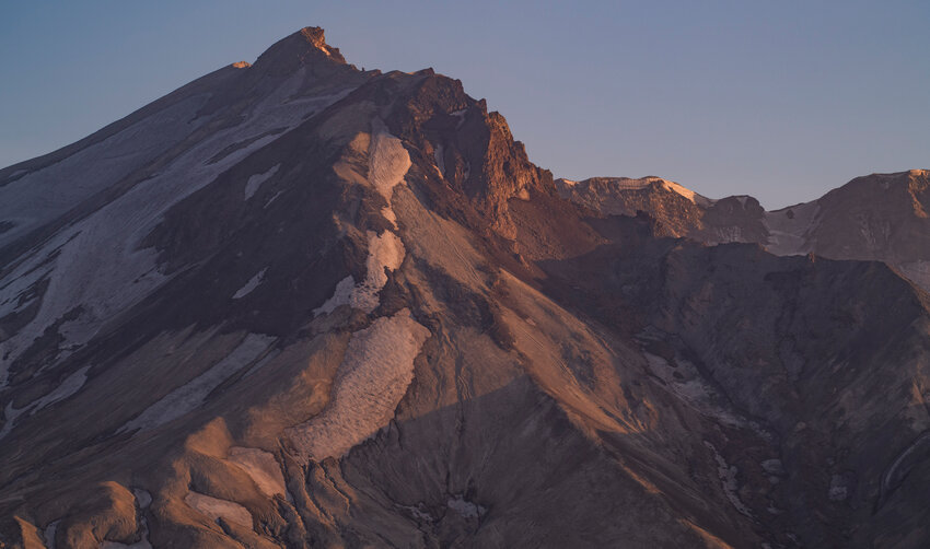 Light shines on the summit of Mount St. Helens as the sun sets on Thursday, July 6.