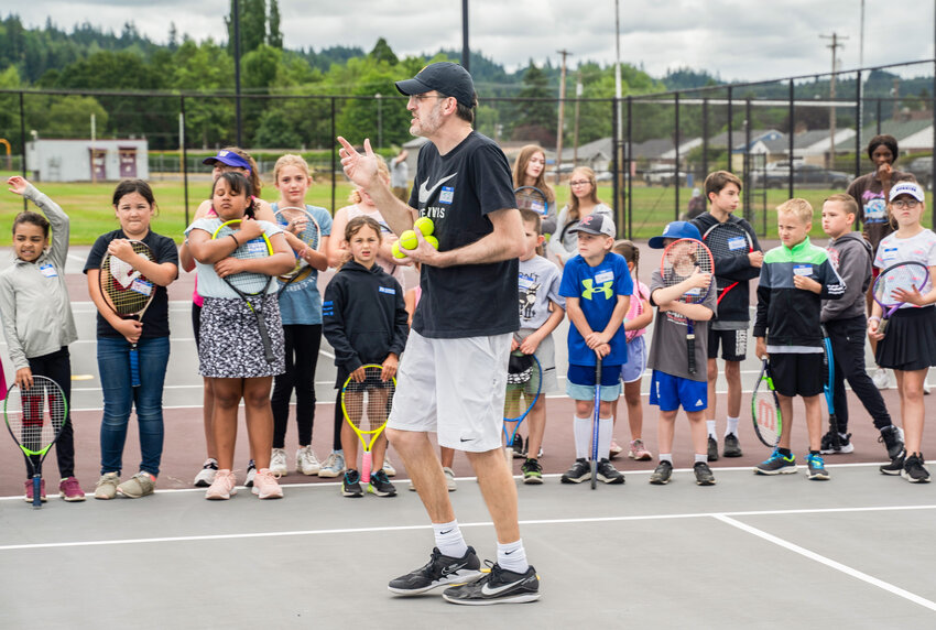 Teaching pro T.J. Underwood teaches kids how to play tennis during the Chehalis Parks and Recreation Summer Tennis Camp on Monday, July 10.