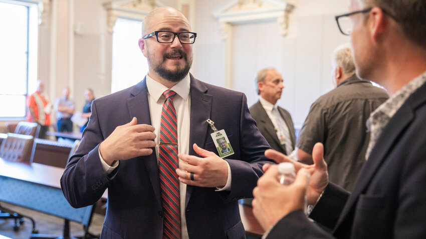Lewis County Manager candidate Ryan Barrett smiles while mingling with visitors at the Lewis County Courthouse in Chehalis on Tuesday, July 11.