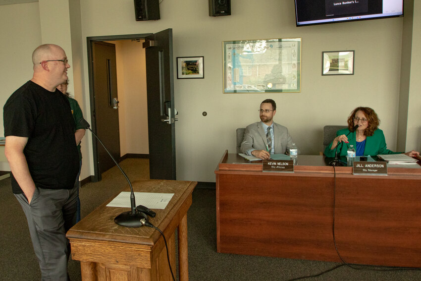 Chehalis's Interim Planning and Building Manager Ron Buckholt stands before the Chehalis City Council on July 10 while being introduced by Chehalis City Manager Jill Anderson.