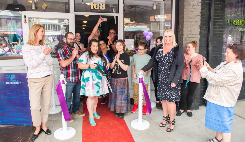 Stephanie Shields, of Zap Master Electrology, smiles after cutting a ribbon for her business in downtown Centralia on Tuesday, July 25.