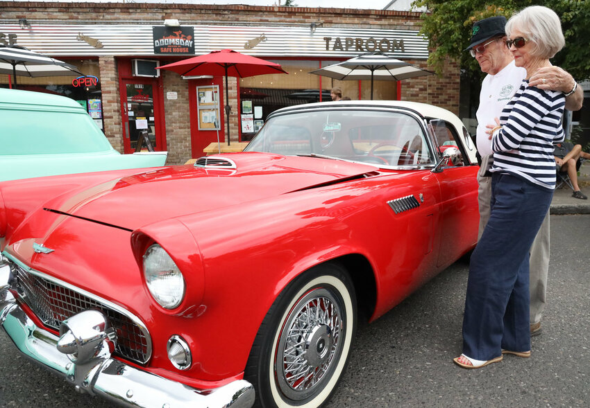Slo Poks founding father Ron &ldquo;Steve&rdquo; Stephens puts his arm around his wife Gertrude Stephens while admiring a 1956 Ford Thunderbird during the Slo Poks car show, Show N&rsquo; Shine, in Vancouver Aug. 17, 2019. The Vancouver couple drove a red 1955 Ford Thunderbird to Reno for their wedding 65 years ago, giving Thunderbirds a special parking spot in their hearts