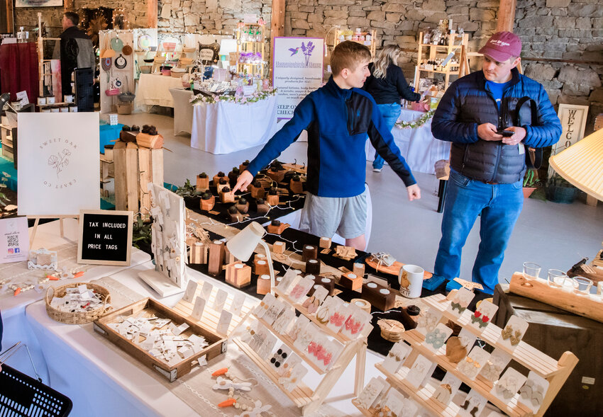 Vistors point and view items on display during the Tenino Arts Spring Market featuring 32 regional artisans inside the Kodiak Room earlier this year. Taxable retail sales in Yelm for the first quarter of 2023 were up dramatically from their 2022 total and nearly double their 2019 total for the same quarter.