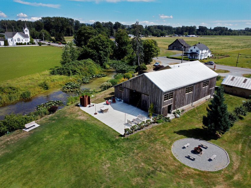 The Saltbox Barn, seen from the air, is an events business, Wednesday, July 26, 2023, in Mount Vernon, Washington. The married couple who owns it risks going out of business if a code change in Skagit County goes through, prohibiting wedding venues from operating in the county where it is zoned for only agriculture on farmlands. (Ken Lambert/The Seattle Times/TNS)