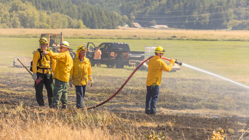 FILE PHOTO &mdash;&nbsp;Kevin Anderson, assistant chief with Riverside Fire Authority, directs crews along Teitzel Road while responding to a brush fire in Centralia on Thursday, August 3.
