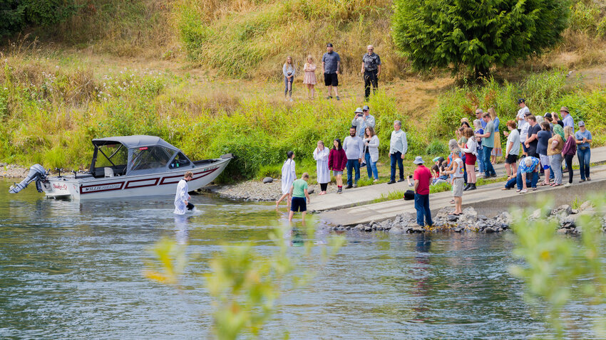 Members of Toledo First Baptist Church hold a baptism in the Cowlitz River on Sunday afternoon.