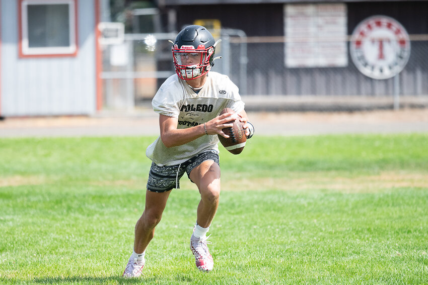 Sophomore quarterback Eli Weeks rolls out during a team drill at at Toledo's practice on Thursday, Aug. 17.