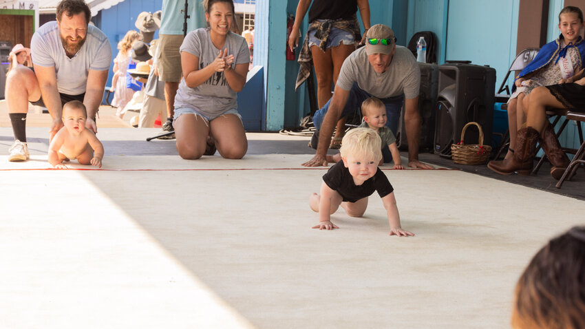 Jackson Arrington, 14 months, crawls to victory during the KELA/KMNT Diaper Derby at the Southwest Washington Fairgrounds on Thursday.