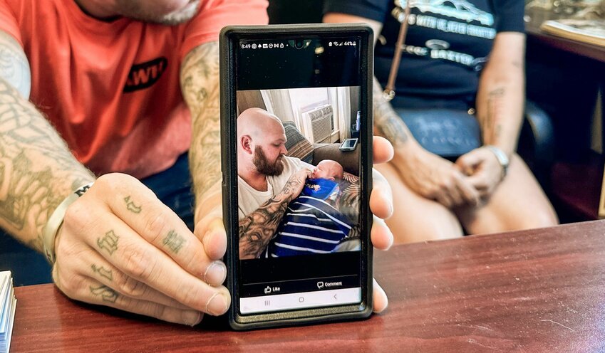 A photo of Jesse Baxter and his son, Paxton, is shown by members of his family during an interview with The Chronicle in Centralia on Friday, Aug. 18.