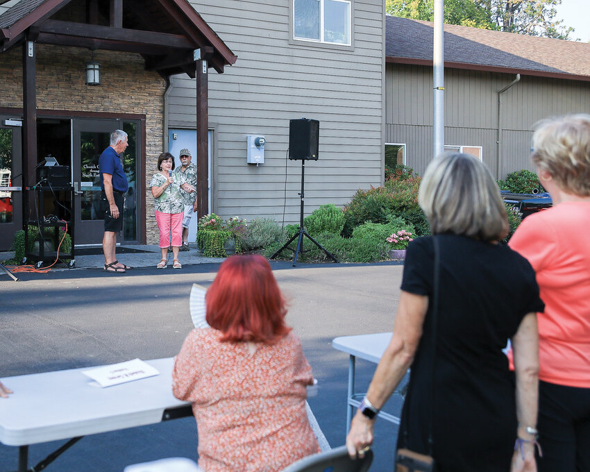 La Center City Council candidate Myrna Leija answers a question asked by a community member during the last farmers market of the season on Thursday, Aug. 24.