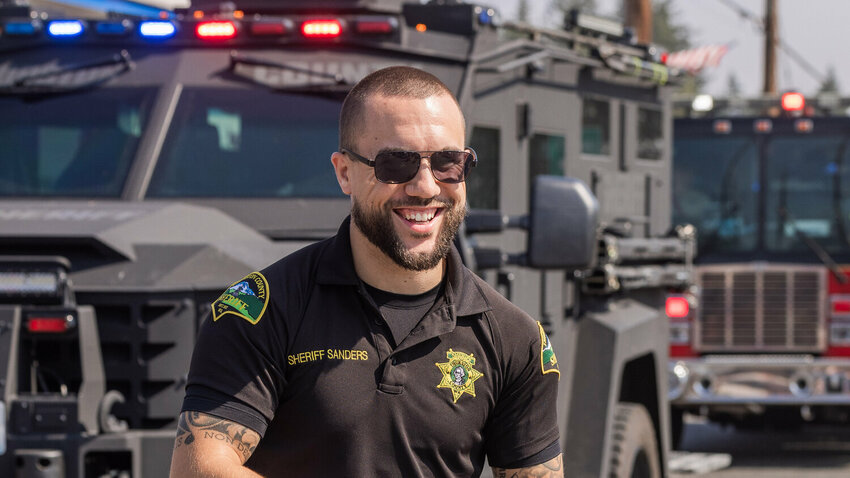 Thurston County Sheriff Derek Sanders walks in the Round-Up Days parade on Saturday in Rainier.