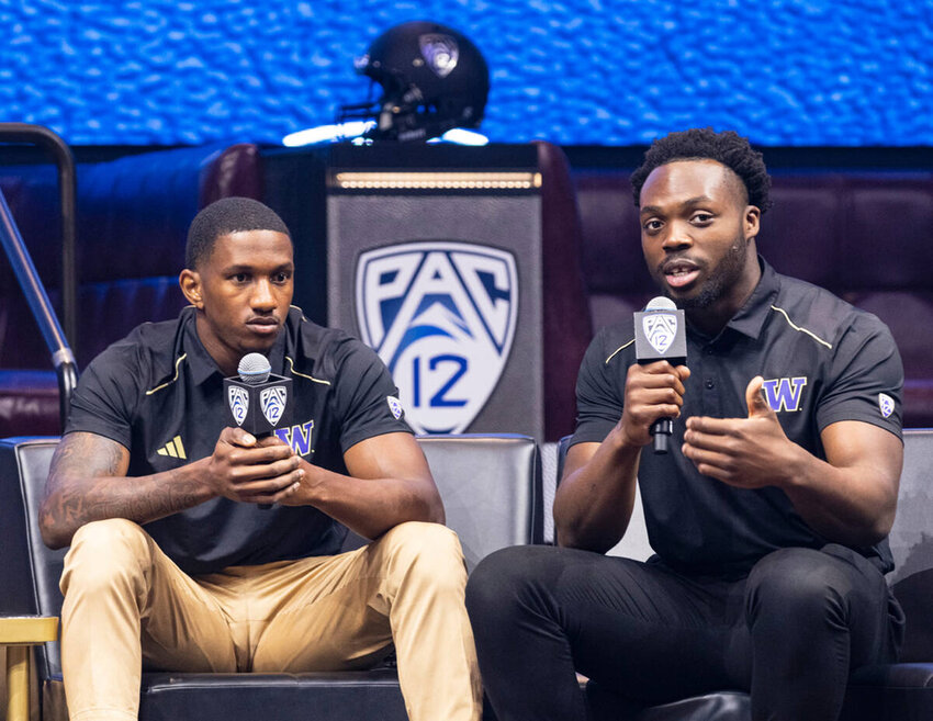 Washington Huskies quarterback Michael Penix Jr., left, listens as linebacker Edefuan Ulofoshio speaks during the Pac-12 Football media day at Resort World, on Friday, July 21, 2023, in Las Vegas. (Bizuayehu Tesfaye Las Vegas Review-Journal TNS) @btesfaye