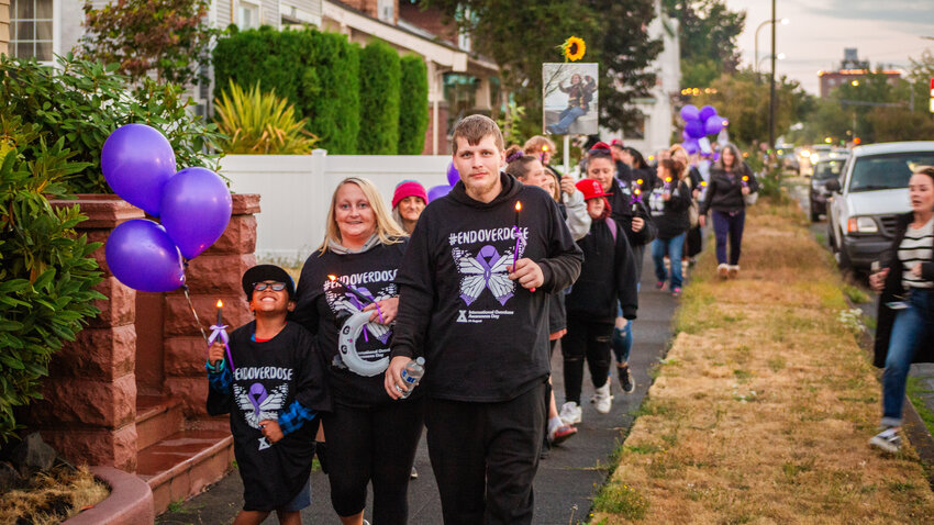 Attendees walk along Pearl Street on the &quot;Night of Illumination.&quot; The walk remembers &quot;those we have loved and lost to addiction, and for the addict who still suffers.&quot;
