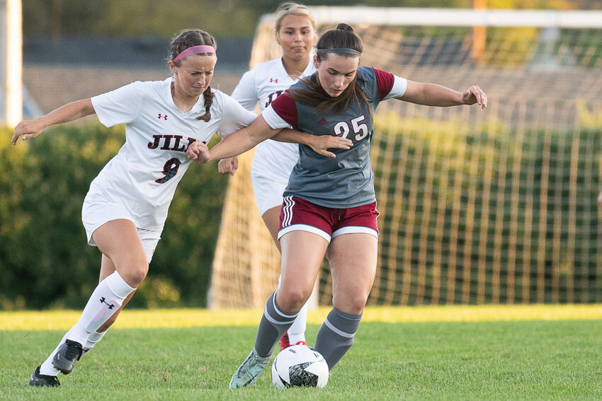 Anna Alexander tries to fend off a defender during the first half of W.F. West's home matchup against R.A. Long on Thursday, Sept. 7.