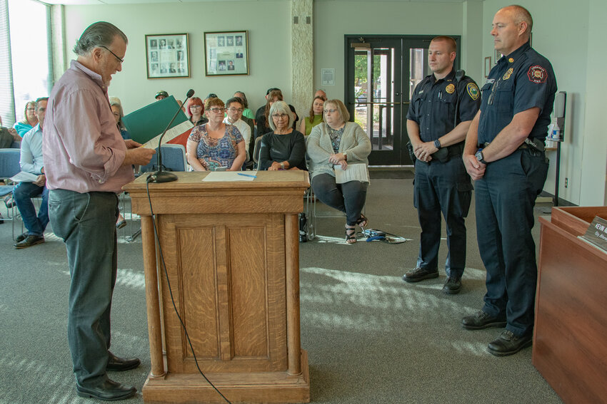 Chehalis Mayor Tony Ketchum, left, reads a proclamation declaring Sept. 11 Patriot Day to Chehalis Fire Chief Adam Fulbright and Chehalis Police Deputy Chief Matt McKnight during the city council meeting on Monday, Sept. 11.