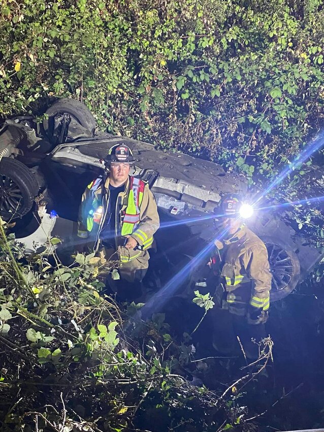 Firefighters respond to a crashed vehicle along state Route 6 near Adna on Thursday night.