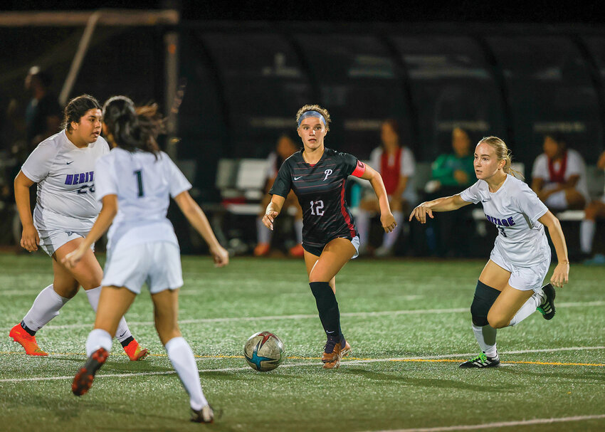 Prairie High School girls soccer senior captain Maddie Thorsen looks downfield with the ball during the Falcons&rsquo; 9-2 victory over Heritage High School on Thursday, Sept. 21.