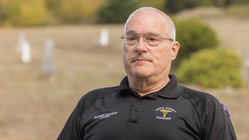 Lewis County Coroner Warren McLeod talks about the work that goes into contacting family after a death during a ceremony for unclaimed remains in Chehalis on Thursday, Sept. 28.