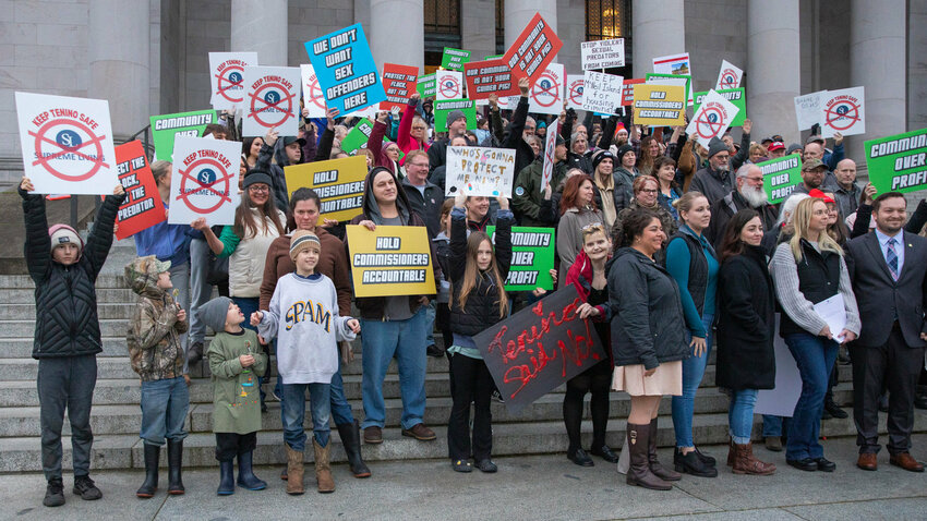 FILE PHOTO &mdash;&nbsp;Tenino residents gather for a photo while protesting Supreme Living housing for sex offenders outside the Washington state Capitol building in Olympia in 2023.