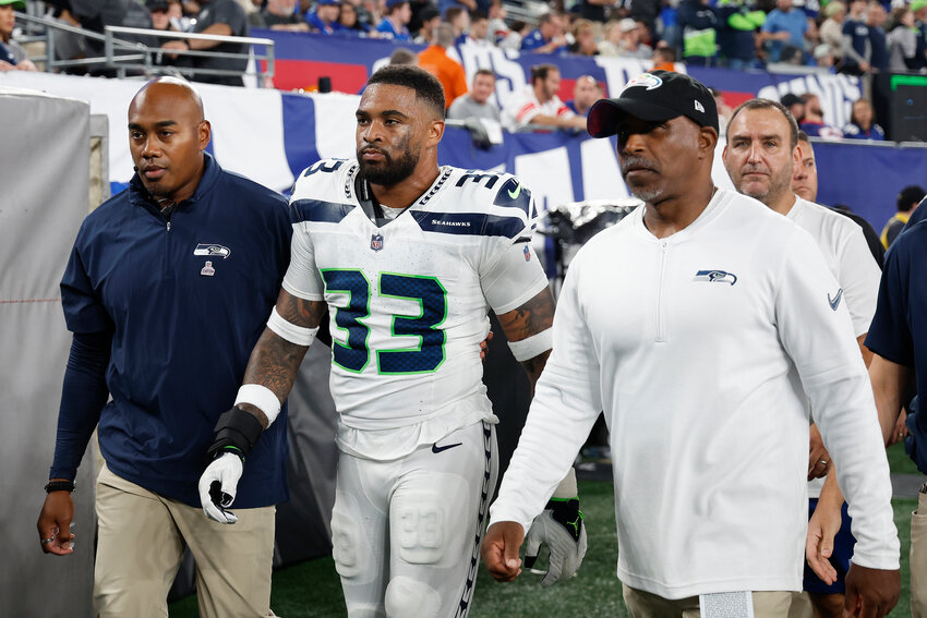 Jamal Adams #33 of the Seattle Seahawks reacts as he walks to the locker room after suffering a concussion during the first quarter against the New York Giants at MetLife Stadium on October 02, 2023 in East Rutherford, New Jersey. (Photo by Sarah Stier/Getty Images TNS)