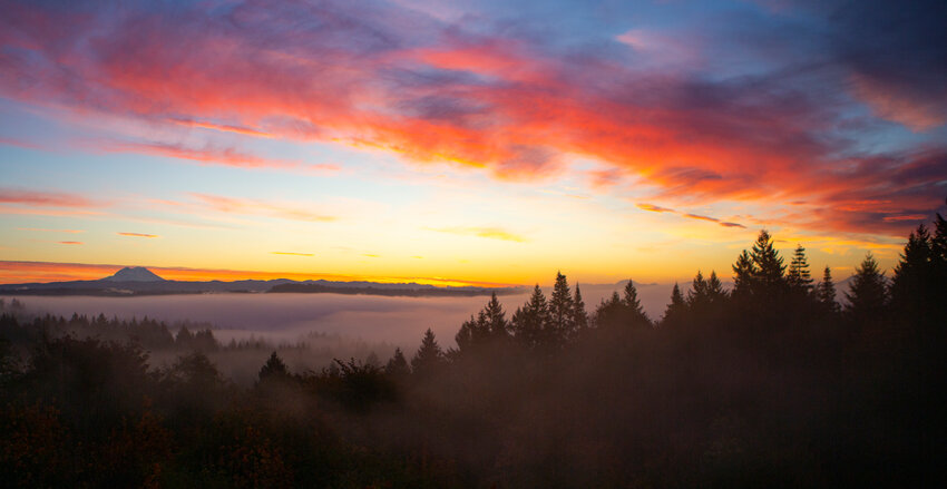 The sky above Chehalis and the Cascade Mountains turns shades of pink, purple, blue and yellow just before sunrise on Friday morning.