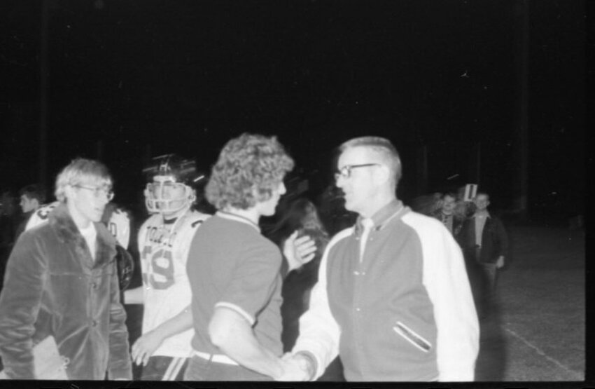 Caption: Toledo coach Ted Hippi shakes his son Rob&rsquo;s hand after his squad beat his son&rsquo;s Rochester team 19-0 on Oct. 19, 1973.