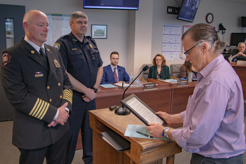 Chehalis Mayor Tony Ketchum reads a proclamation declaring Saturday, Oct. 28, National First Responders Day while the city's Fire Chief Adam Fulbright and Police Chief Randy Kaut await to receive the proclamation on behalf of first responders during the Chehalis City Council meeting on Monday, Oct. 23.