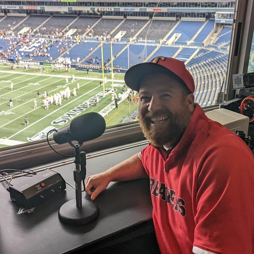 Dave Montgomery sits at the PA microphone before announcing a Tenino High School football game at Lumen Field in Seattle during the 2022 prep football season.