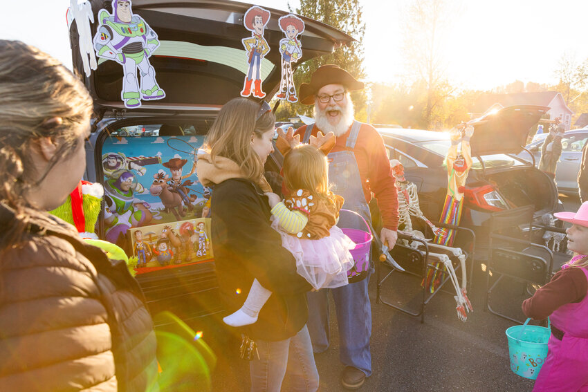 Visitors greet costumed attendees as candy is passed out during a Trunks with Treats event at the Veterans Memorial Museum on Sunday, Oct. 29.