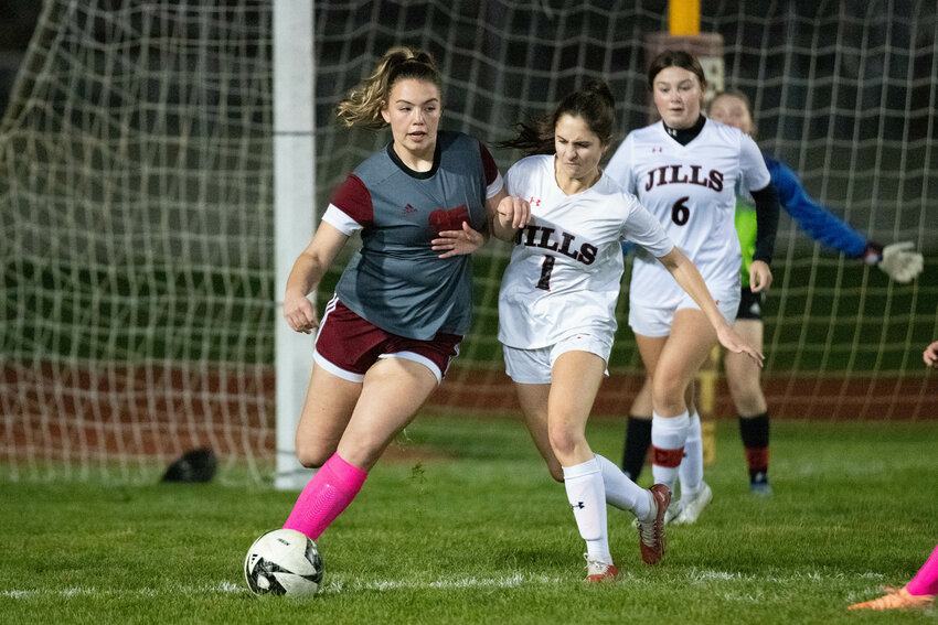 W.F. West's MaKenzie Dotson battles with R.A. Long Olivia Durrett during the first half of the Bearcats' first-round matchup against RAL in the district tournament on Oct. 31.