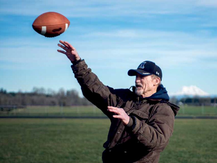 Warren Robertson throws a football at the Adna High School football stadium in 2016 while talking about his stint as a member of a U.S. military football team  in Japan during the Korean War. He landed on the team due to a case of mistaken identity. His story was printed in Sports Illustrated in the 1960s.