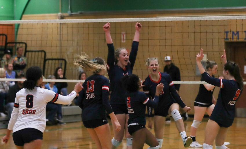 The Wolves celebrate after scoring a point late in their 3-2 win over R.A. Long in the first round of the 2A District 4 Tournament on Nov. 2. in Tumwater.