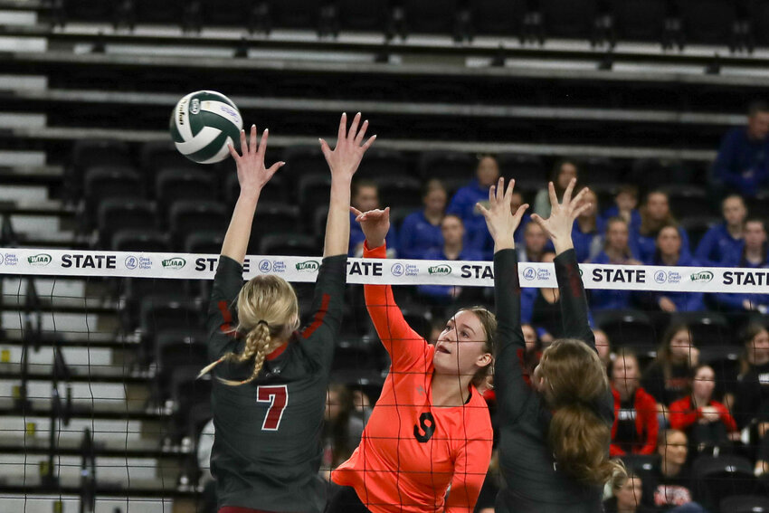 Keira O'Neill spikes the ball past two Okanogan defenders during Napavine's first-round matchup at the state tournament on Nov. 8 in Yakima.