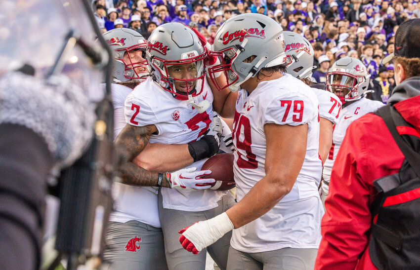 Cougars receiver Kyle Williams (2) is lifted up after scoring a touchdown during the Boeing Apple Cup Series football game in Seattle against the University of Washington Huskies on Saturday, Nov. 25.
