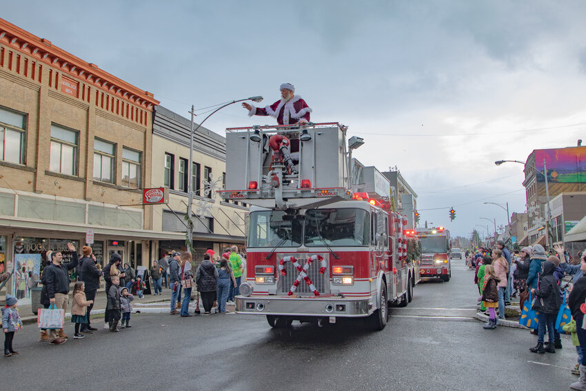 Santa is seen waving from atop the Chehalis Fire Department's ladder truck during the Centralia-Chehalis Chamber of Commerce &quot;Aloha Christmas&quot; Santa Parade on Saturday, Dec. 2.