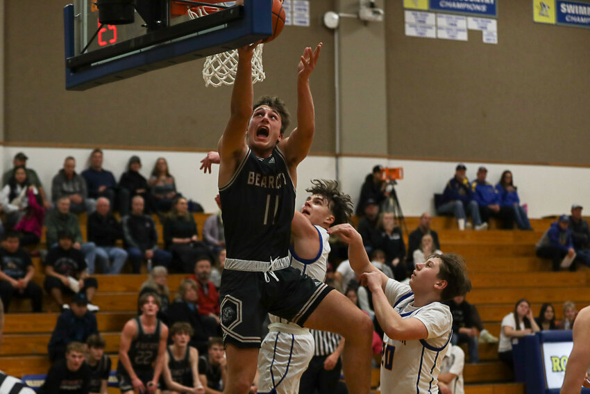 Grady Westlund fights through contact for a layup during W.F. West's win at Rochester on Dec. 5.