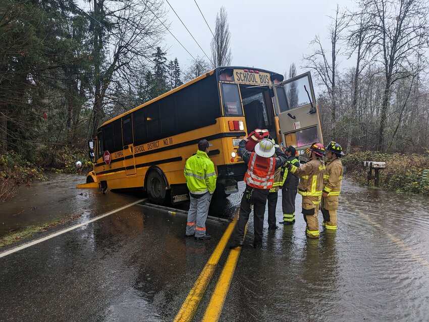 Firefighters helped rescue students from a bus that got stuck in flood waters northwest of Black Lake Tuesday morning.