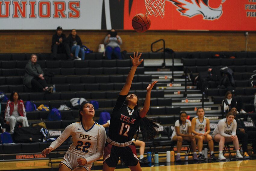 Senior Maria Casihan puts up a shot next to Fife's Ariana Vaeao on Thursday, Dec. 28 at Centralia High School.