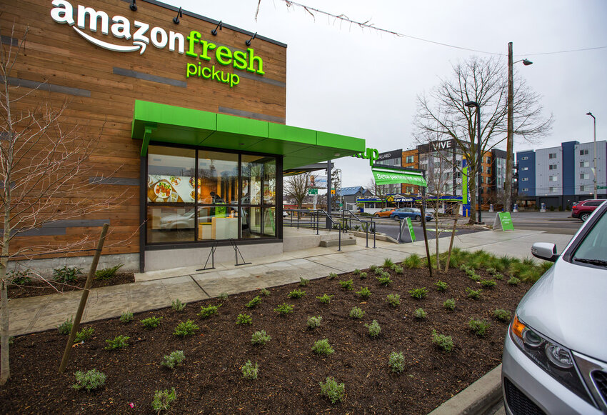 Herb plants grow along the sidewalk outside Amazon Fresh in Ballard.